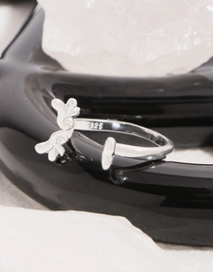 Macro shot of S925 sterling silver stamp on minimalist wing heart adjustable open ring