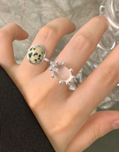 Detail of S925 sterling silver ring with dalmatian stone and oval crystal on hand