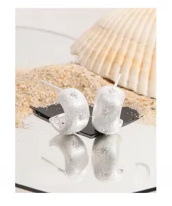Detailed view of matte S925 silver starburst earrings with sparkling zircon accents