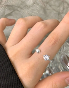 Macro shot of S925 silver ring featuring a sparkling zircon and minimalist metal bead