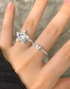 Détail macro du lot de bagues étoile en argent S925 avec zircon cœur violet et texture