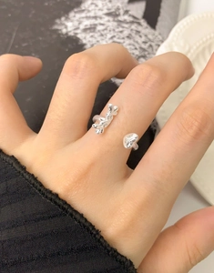 Close-up of liquid metal silver ring with irregular geometric design on finger