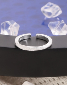 Macro shot of S925 sterling silver Mobius ring with matte sand and polished finish