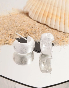 Detail of S925 sterling silver C-shaped earrings with brushed texture and star pattern