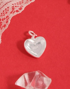 Macro shot of S925 sterling silver heart pendant showing authentic hallmarked material detail