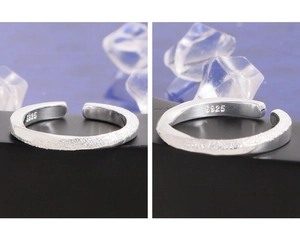 Macro detail of S925 sterling silver Mobius ring with frosted and polished finish