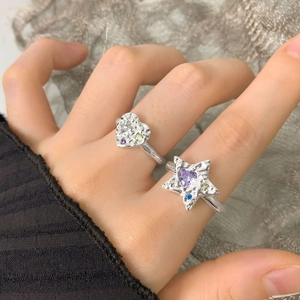 Lava texture heart and star silver rings set with colorful zircons on fingers