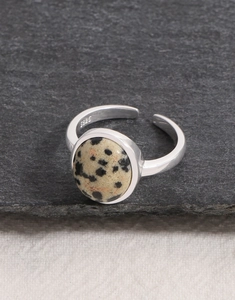 Macro shot of S925 sterling silver ring featuring a round natural dalmatian stone