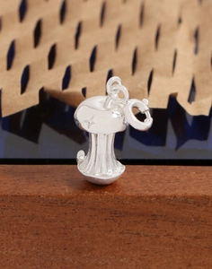 Macro shot of silver mushroom pendant with engraved star detail for DIY jewelry