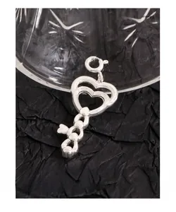 Detailed macro of S925 sterling silver heart-shaped key pendant with spring clasp