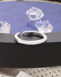 Macro shot of silver Mobius ring showing contrasting polished and matte brushed textures