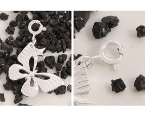 Macro detail of S925 sterling silver butterfly pendant showing 925 stamp and textured wings