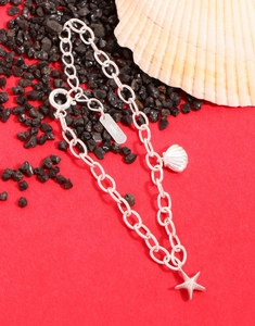 Detail of S925 sterling silver starfish and seashell charms on a delicate chain bracelet