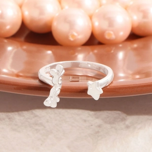 S925 Sterling silver open ring with wing heart and star design on ceramic plate
