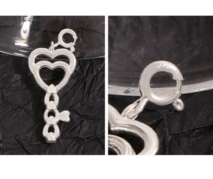 Macro detail of S925 sterling silver heart key pendant showing clear 925 hallmark