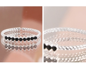 Macro detail of S925 sterling silver hallmark on black zircon twisted rope open ring