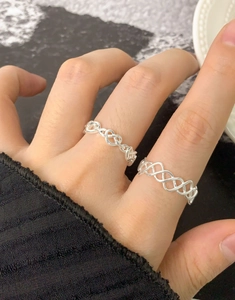Détail de la bague en argent S925 à maille creuse et motif cœur sur main de mannequin
