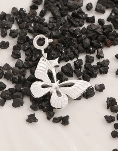 Detailed close-up of S925 sterling silver butterfly pendant with intricate hollow design
