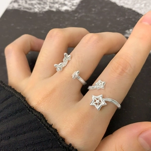 S925 sterling silver adjustable open ring with wing and star design on a female model
