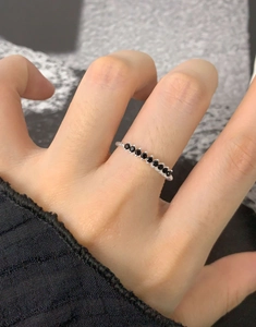 Close-up of S925 sterling silver ring featuring eight prong-set black zircon stones