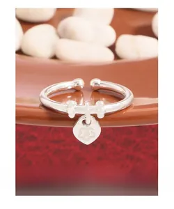 Macro shot of S925 sterling silver heart tag ring with floral engraving and open design
