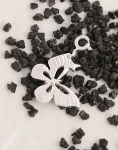 Detailed view of S925 sterling silver butterfly pendant with textured wings and clasp
