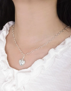 Close-up of S925 sterling silver heart pendant with textured finish on O-chain necklace