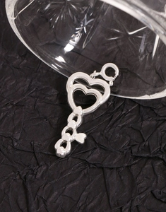Macro shot of S925 sterling silver heart key pendant with detailed engravings