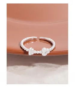 Macro shot of S925 silver beaded ring featuring heart and zircon flower details