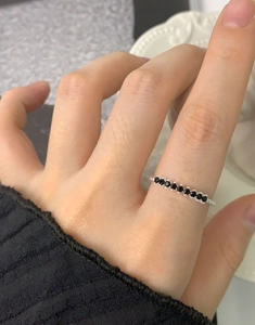 Macro detail of S925 sterling silver twist ring featuring seven inlaid black zircons