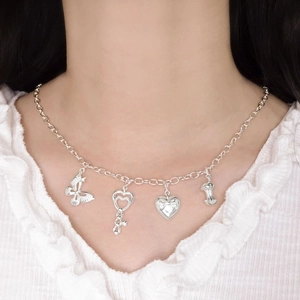 S925 sterling silver heart key and butterfly multi-pendant charm necklace on a model