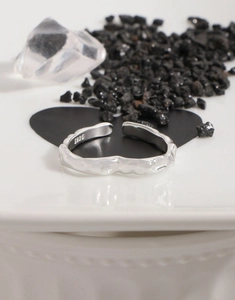 Detail shot of molten texture heart ring with S925 sterling silver stamp on inner band