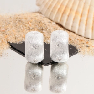 Brushed S925 sterling silver star stud earrings with zircon on a beach sand setting