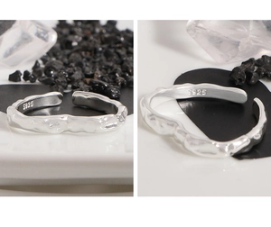 Macro detail of S925 sterling silver ring featuring irregular lava texture and silver stamp
