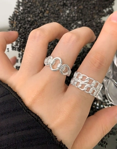 Detailed view of interconnected and double-row hollow S925 sterling silver rings on hand