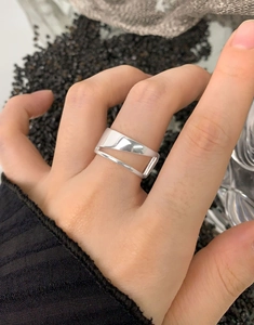 Close-up of S925 sterling silver geometric hollow ring on finger with modern cutouts