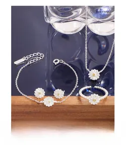 Detailed close-up of S925 sterling silver daisy jewelry set with white enamel and yellow zircon