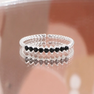 S925 sterling silver twist ring with nine black zircon stones in an open adjustable band