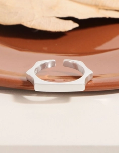 Detailed view of S925 sterling silver stamp on minimalist geometric open ring