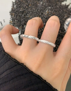 Close-up of S925 sterling silver heart rings with lava texture and woven patterns