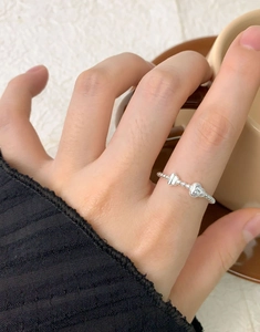 Close-up of S925 sterling silver beaded flower ring with sparkling zircon on model finger