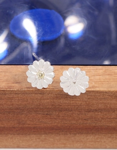 Macro shot of S925 sterling silver daisy earrings with yellow zircon and purity stamp