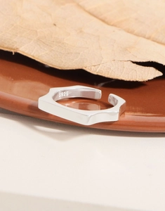 Close-up of S925 sterling silver hallmark on minimalist geometric polygon ring band