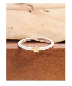 Detail shot of a silver S925 adjustable star ring on a rustic wooden surface