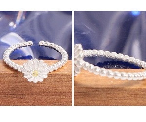 Macro shot of S925 sterling silver stamp on daisy beaded ring with white enamel petals