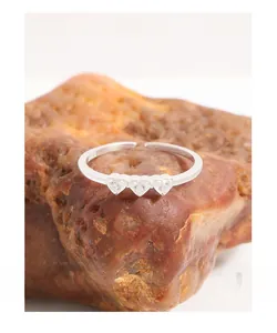 Close-up of S925 sterling silver ring featuring three heart-shaped cubic zirconia stones