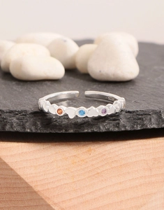 Macro shot of S925 sterling silver ring with colorful zircons and heart relief details