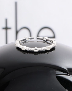 Detailed shot of S925 sterling silver ring with hollow hearts and hallmark engraving