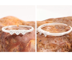 Detail of three zircon heart gems and S925 sterling silver hallmark on the ring band