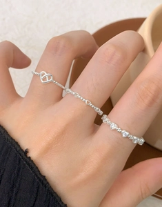 Detailed view of silver S925 heart rings with beads and sparkling zircon accents